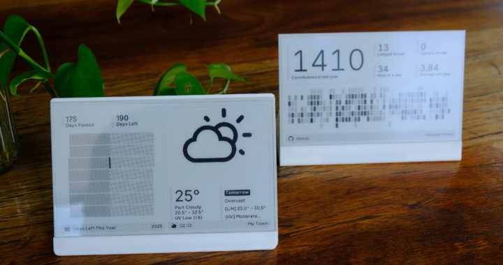 Two e-ink displays show weather and activity stats on a wooden table with plants nearby.