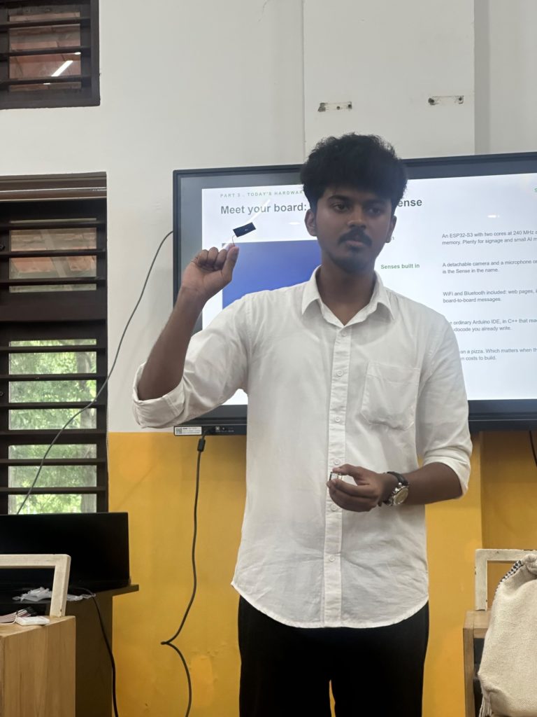 Abhinav Krishna holding a XIAO ESP32S3 Sense board while teaching at the SwitchIt workshop, EMEA College