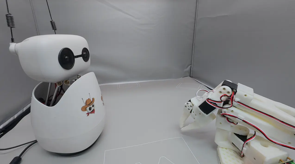 Reachy Mini robot demonstrating AI and robot arm interaction, SOARM with Reachy mini project