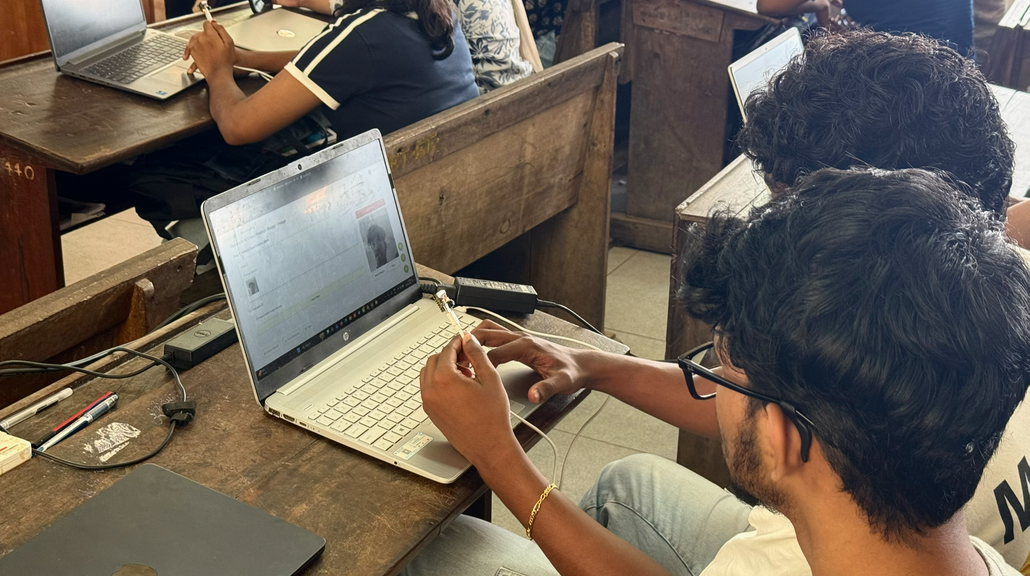 A student uploading a model to the XIAO ESP32S3 Sense at the workshop